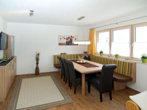 een woonkamer met een eettafel en stoelen bij Holiday Home Schiestl - MHO753 by Interhome in Ramsau im Zillertal
