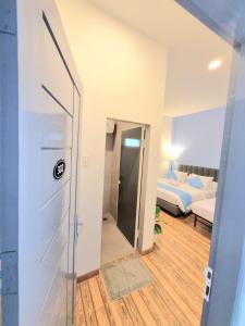 a room with a door leading to a bedroom at Zizi Homey Cemara Asri 302 in Pulauberayan Dadap