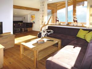 a living room with a couch and a table at Apartment Schoppengrub - BMG196 by Interhome in Bramberg am Wildkogel