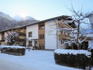 a building with snow on the ground in front of it at Apartment Martina - MHO275 by Interhome in Mayrhofen