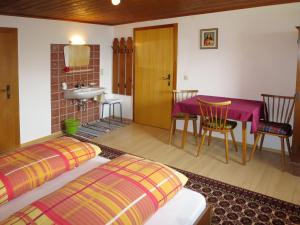 a room with two beds and a table and a sink at Apartment Bloserhof by Interhome in Zellberg