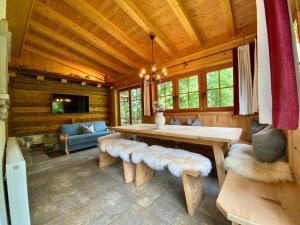 a living room with a table and benches in a cabin at Apartment Sonneck - MHO554 by Interhome in Ramsau im Zillertal