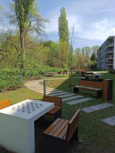 a park with benches and a table and a playground at Solaris Bella Apartment- Tauron Arena in Kraków