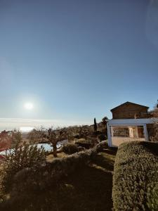 a house on a hill with a view of the ocean at Pamperduto Country Resort in Porto Potenza Picena