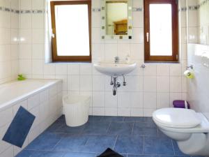 a bathroom with a sink and a tub and a toilet at Apartment Brix - BRG120 by Interhome in Bruck an der Großglocknerstraße