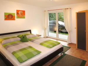 a bedroom with a bed and a window with a car outside at Apartment Bair - MHO535 by Interhome in Hippach
