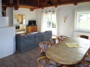 a kitchen and living room with a wooden table and chairs at Chalet Jenneweinhütte - ZAZ408 by Interhome in Zell am Ziller