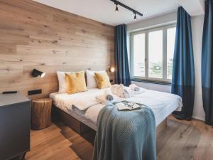 a bedroom with a bed with a wooden wall at Apartment Mariandl am Meer-4 by Interhome in Binz