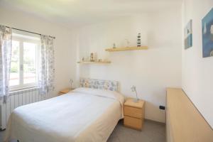 A bed or beds in a room at Lacona Mare - HelloElba