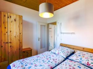 a bedroom with a bed with a wooden headboard at Apartment von Dollen-1 by Interhome in Oberndorf