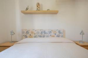 A bed or beds in a room at Lacona Mare - HelloElba