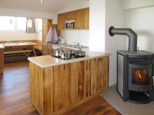 a kitchen with a wood stove in a kitchen at Apartment Daniel by Interhome in Hollersbach im Pinzgau