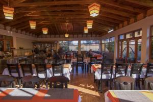 a dining room with tables and chairs in a restaurant at Tunupa Lodge Hotel in Ollantaytambo