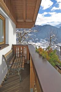 a bench on a balcony with a view of the mountains at Holiday Home Margit - MHO786 by Interhome in Hippach