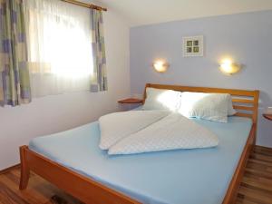 a bedroom with a blue bed with a window at Holiday Home Margit - MHO786 by Interhome in Hippach
