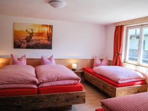 a bedroom with two beds and a window at Holiday Home Geislerhütte - MHO685 by Interhome in Ramsau im Zillertal