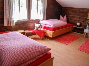 a bedroom with two beds and a window at Holiday Home Geislerhütte - MHO685 by Interhome in Ramsau im Zillertal