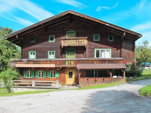 a large wooden barn with a yellow door at Holiday Home Geislerhütte - MHO685 by Interhome in Ramsau im Zillertal