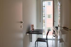a room with a desk and a window with a laptop at 50 metri da Fiera Milano - Business Friendly in Milan