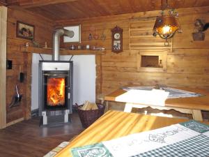 a living room with a fireplace in a log cabin at Chalet Simonhütte - MHO640 by Interhome in Hippach