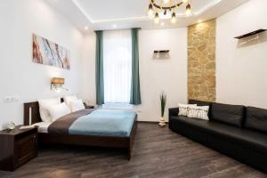 a bedroom with a bed and a couch at Comfy New apartment at Castle in Budapest