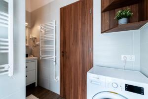 a laundry room with a white washer and dryer at Comfy New apartment at Castle in Budapest
