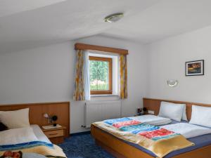 a bedroom with two beds and a window at Apartment Markus - ZAZ760 by Interhome in Mühlfeld