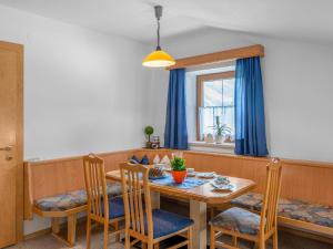 jadalnia ze stołem i krzesłami oraz oknem w obiekcie Apartment Markus - ZAZ760 by Interhome w mieście Mühlfeld