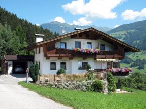 a house in the mountains with flowers on it at Apartment Markus - ZAZ760 by Interhome in Mühlfeld