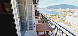 a balcony with a table and a view of the ocean at Magnifique appartement avec balcon vue mer à l'entrée d'Ajaccio in Ajaccio