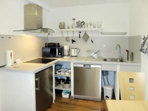 una pequeña cocina con fregadero y microondas en Apartment Tamerl - MHO160 by Interhome, en Schwendau