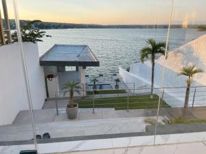 a house with a boat in the water at Quinta Jalisco Vacation in Tequesquitengo
