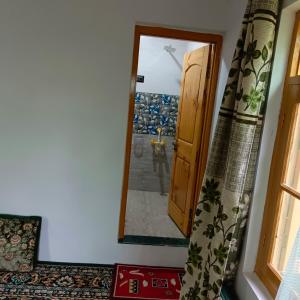 a room with a door and a mirror at The Himalayan Inn homestay in Gulmarg