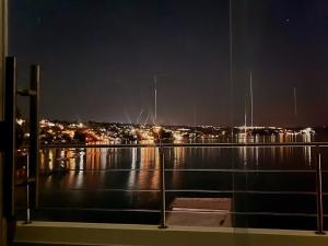 a view of a city at night from a balcony at Quinta Jalisco Vacation in Tequesquitengo
