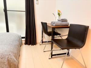 a bedroom with a desk and a chair and a bed at IXO Ts2 in Tokyo
