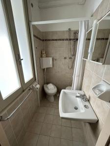 a bathroom with a sink and a toilet and a shower at Camere Capinera in Cesenatico