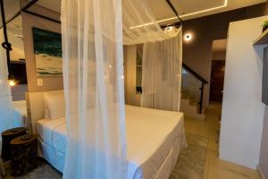 Cama ou camas em um quarto em Amora Hotel Maresias