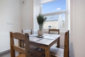 a dining room table with a potted plant on it at Stylish Home near St Johns Chapel, Sleeps 6 in Saint Johns Chapel