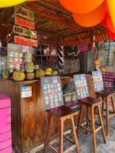 a group of stools in front of a fruit stand at Hostal la Canoa in Playa Blanca