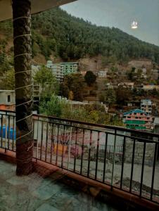 a view of a city from a balcony at Al Sadiq Guest House in Murree