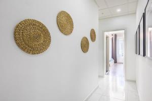 een gang met een witte muur met een heleboel hoeden erop bij Newly designed central studio in Boedapest