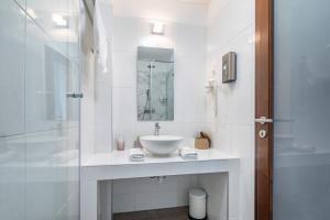 a white bathroom with a sink and a shower at 5 House Winery - Perfect Chill in Somlószőlős