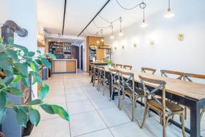 a dining room with a long table and chairs at Perfect relax in Somlószőlős