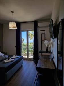 a bedroom with a bed and a window with a view at Villa Lekythos in Agrigento