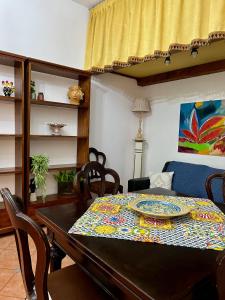 ein Esszimmer mit einem Tisch und einem Teller darauf in der Unterkunft Casa del Duomo in Syrakus + 33 Fotos