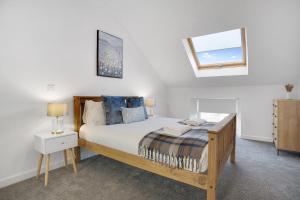 a bedroom with a wooden bed and a window at Stylish Home near St Johns Chapel, Sleeps 6 in Saint Johns Chapel
