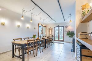 a kitchen and dining room with a long table and chairs at Slow living - perfect vacation in Somlószőlős