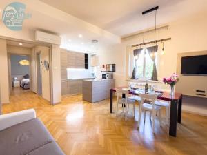 a living room and kitchen with a table and a dining room at Viale Miramare 123/1 Tirabora Short Rent in Trieste