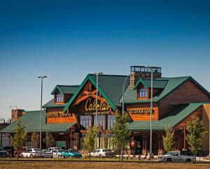 a large building with a coca cola sign on it at 3 BDR - Bonus Room - King Bed - Garage - Near Airport in Regina