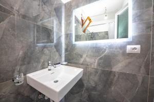 a bathroom with a sink and a mirror at Enel Villa in Sarandë